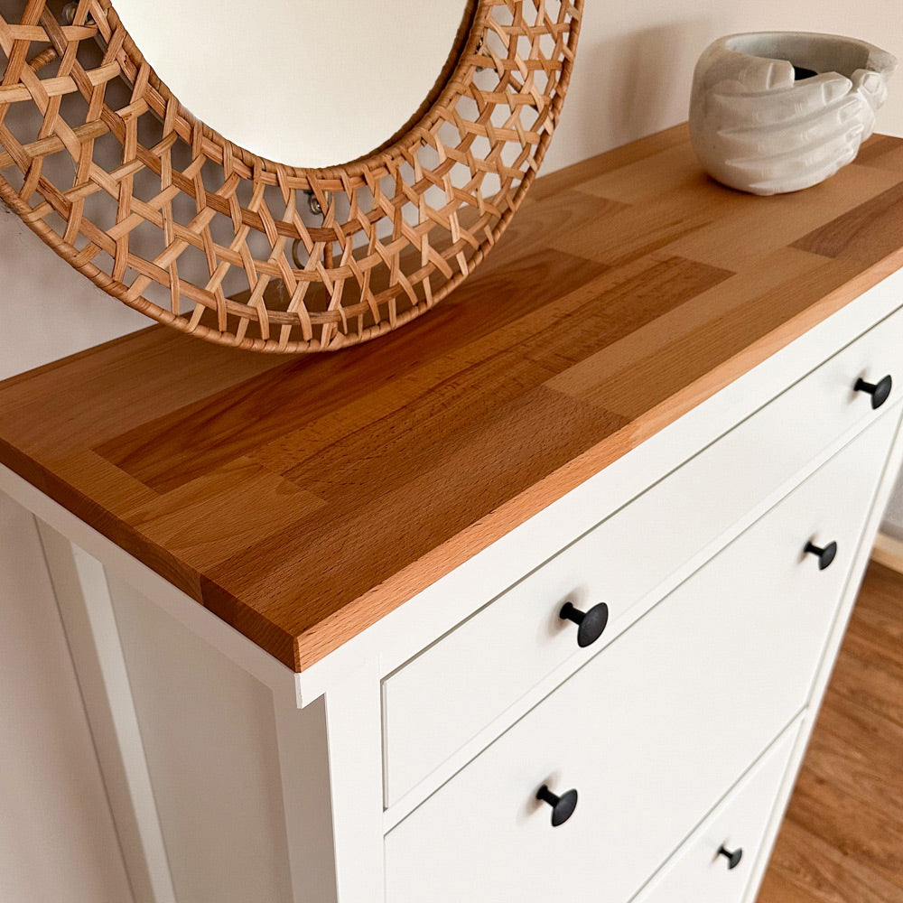 Eine geölte Buchenholzplatte liegt passgenau auf einem weißen IKEA Hemnes Schuhschrank mit 2 Fächern. Auf der Holzplatte steht ein Spiegel.