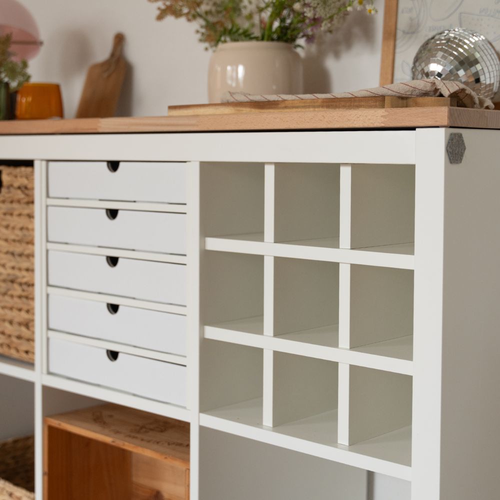 Kallax Regal von IKEA mit einem passgenauen Regalteiler, der neun Fächer schafft und einem weiteren Einsatz mit 6 Pappschubladen zur Aufbewahrung von Papier und Unterlagen.
